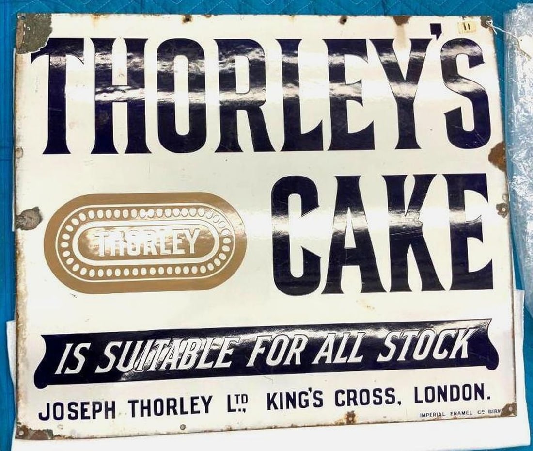 English Thorley's Cakes Advertising Enameled Sign: Circa 1930, the white enameled metal rectangular sign with black lettering "THORLEY'S/ CAKES/IS SUITABLE FOR ALL STOCK in black box with white lettering. Dimensions: 27" x 32" (68.6 x 81.3 cm) Overall