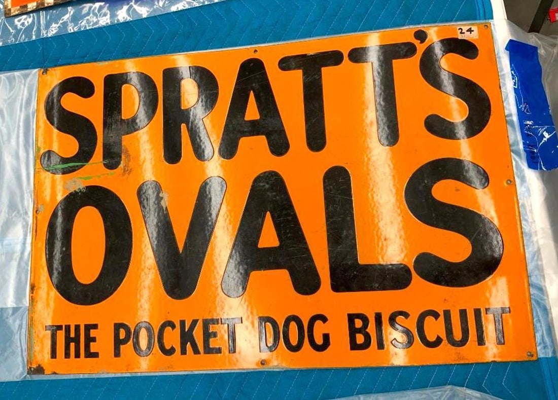 Spratts Ovals Advertising Sign: Circa 1930, the orange enameled metal rectangular sign with black lettering reading "SPRATT'S/OVALS/THE POCKET DOG BISCUITS". Date: c. 1930; Medium: metal, enamel; Dimensions: 20" x 30" (50.8 x 76.2 c