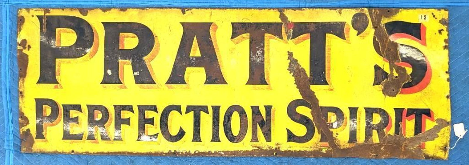 Pratts Perfection Spirit Advertising Sign: Circa 1930, the yellow enameled advertising sign reading "PRATT'S/PERFECTION SPIRIT" in black lettering. Dimensions: 18" x 52" (45.7 x 132.1 cm) Condition: Misshapen overall with extensive wear. Corro