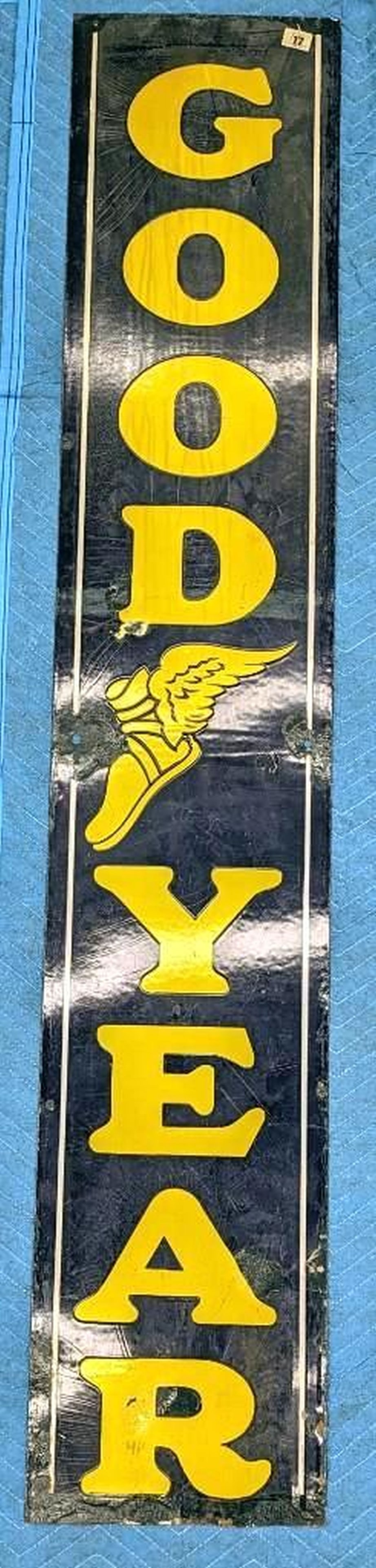 Goodyear Pillar Advertising Sign: Circa 1930, a vertical dark blue enameled metal sign reading "GOODYEAR" in yellow lettering with blue surround. Dimensions: 65" x 12" (165.1 x 30.5 cm) Overall fair to good condition, Some enamel loss