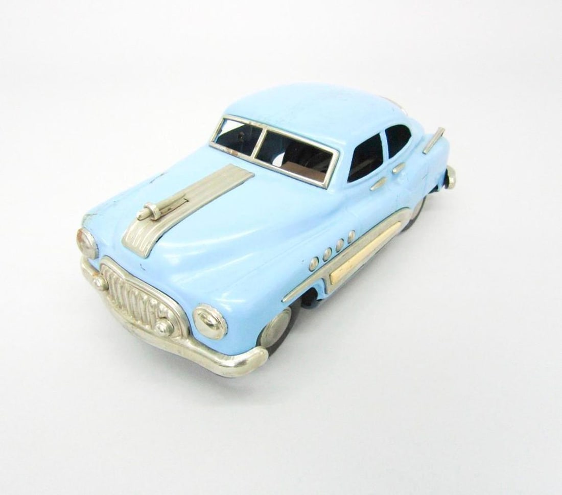 Linemar Chevrolet Sedan Friction Car: Circa 1950s, the pale blue toy Chevrolet saloon car with silver trim; lithograph interior. Dimensions: 4" x 4.25" x 9". Condition: Surface scratches and rusted chrome parts throughout. Cracks on rear
