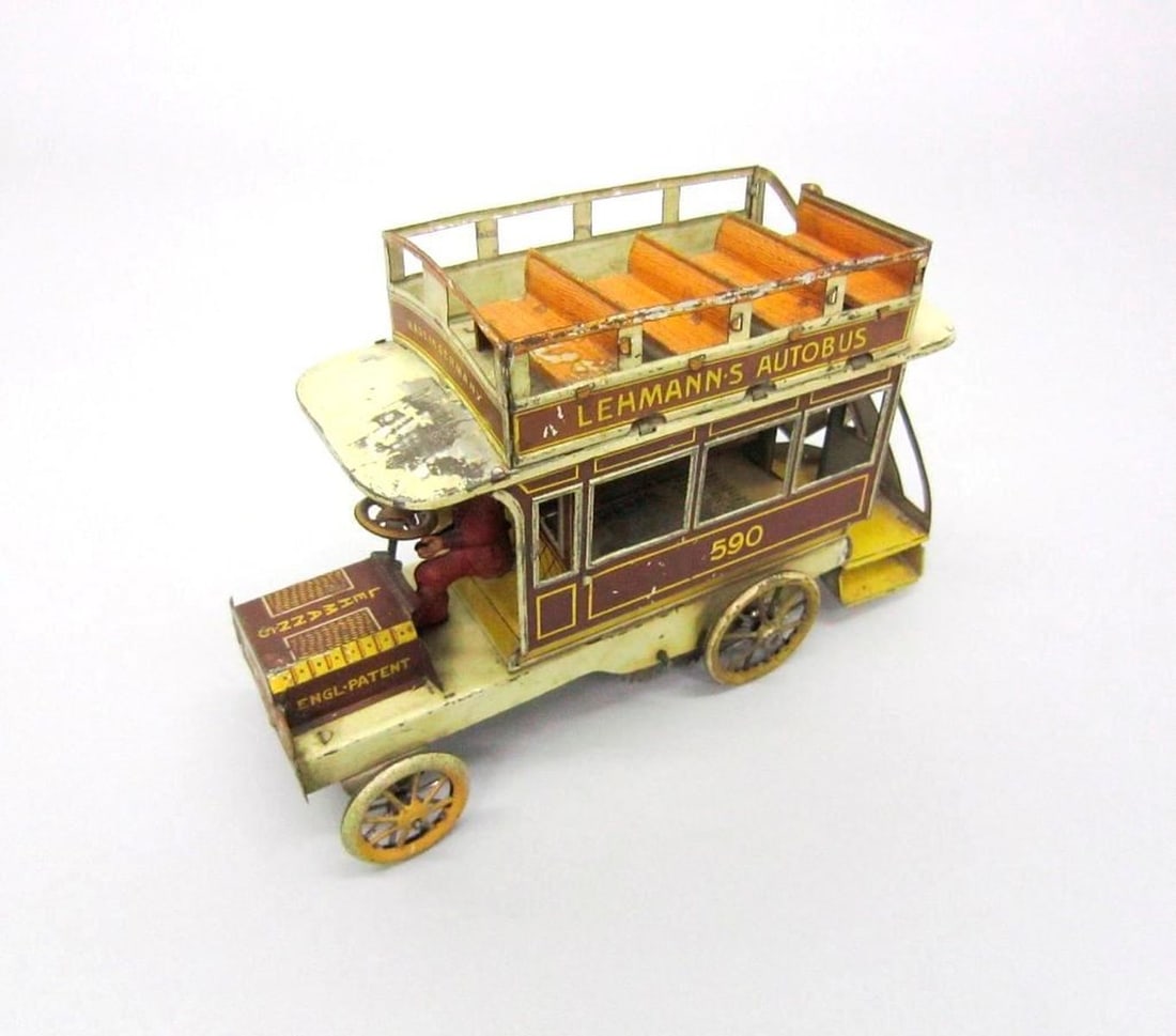 German Lehmann Litho Tinplate Autobus: Circa 1904, lithographed tinplate Lehmann Autobus toy bus with spring motor and key; includes a paper advertisement for "The Celebrated Autobus". Dimensions: 5" x 3.5" x 8" (12.7 x 8.9 x 20.3 cm). Con