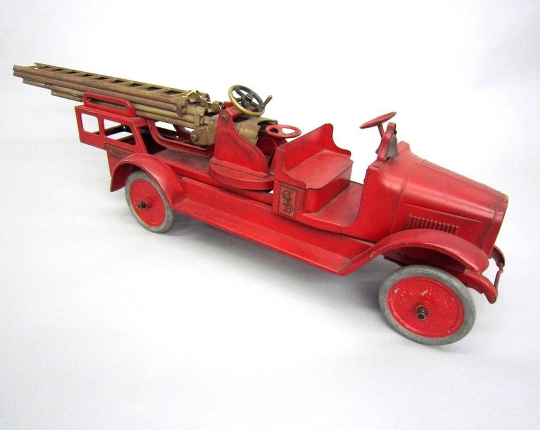 toy: Moline Pressed Steel Company, Buddy 'L' aerial truck: Red toy truck with chrome tires and rusted ladders; maker's decal on floor board "Buddy L"/quality toys/built by Moline Pressed Steel Co./Moline, IL"; "CFD" decal on driver's and passenger side panels