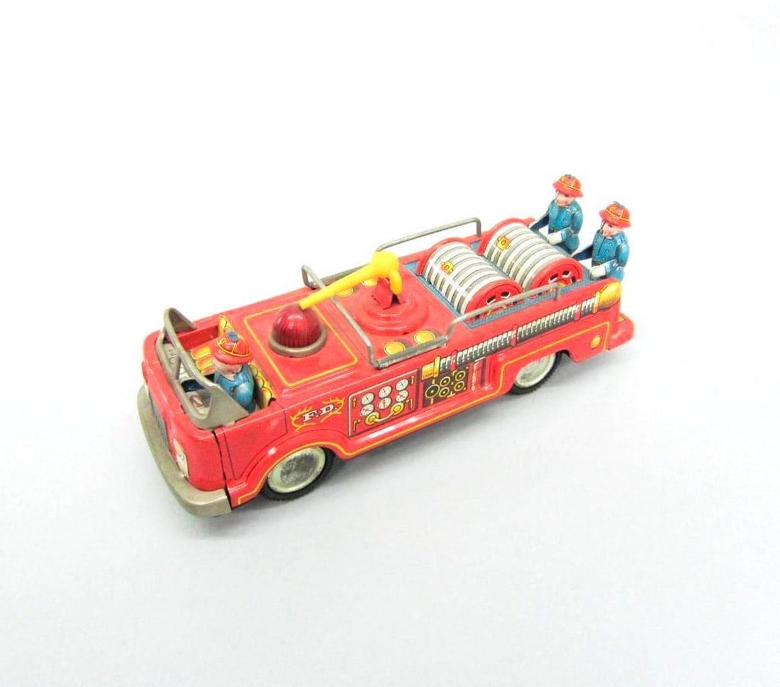 Kokyu Trading Company Fire Truck: The tinplate toy fire truck fitted with three figures and a hose nozzle mounted on top; "Japan" printed on rear Dimensions: 2 .5" x 2.25" x 7" (6.4 x 5.7 x 17.8 cm). Condition: Abrasions on wheel hub