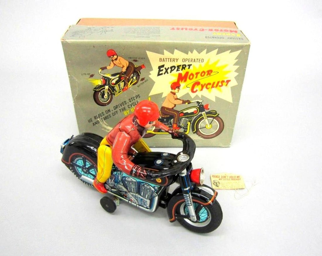 Japanese Masudaya Atom Tin Motorcycle and Rider: Circa 1950s, the collectible battery powered toy motorcycle with motorcyclist (Masudaya Atom); lithographed with engine detail; rubber tires; headlamp; maker's stamp on bottom of motorcycle, "Modern T