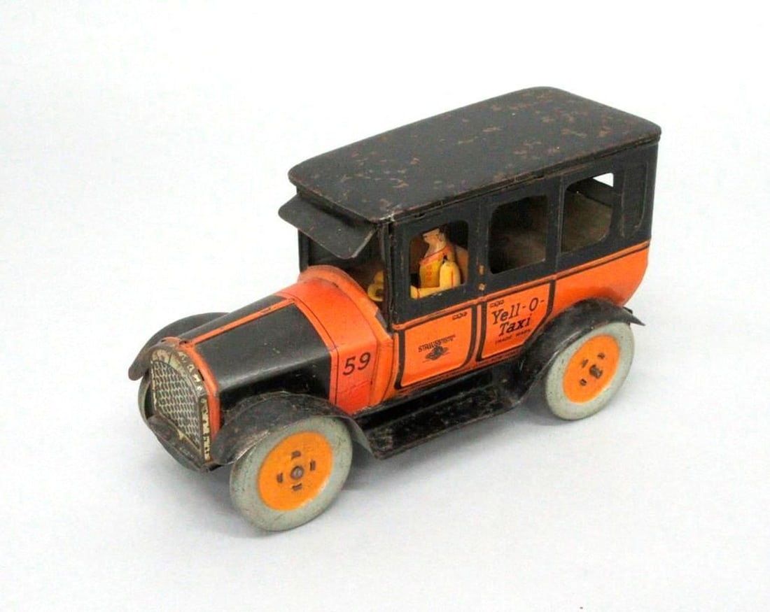 Ferdinand Strauss Corporation Yell-O-Taxi: Lithographed tinplate toy taxi with driver and Strauss Mechanical Toys globe logo on doors. Dimensions: 4.5" x 4.25" x 9.75" (11.4 x 10.8 x 24.8 cm) Condition: Wheels are dented; abrasions to the pain