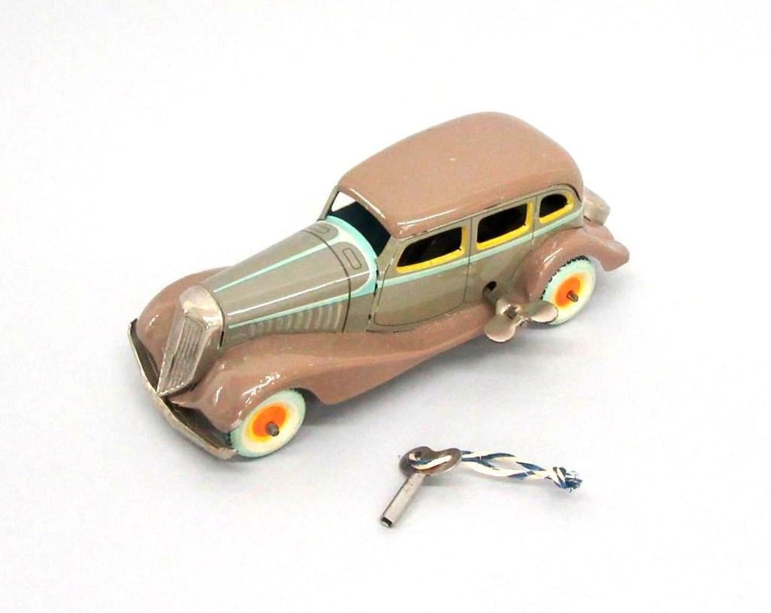 Kosuge, Graham Paige "No. 3" car: Circa 1933, a lithographed tinplate clockwork toy car; light brown color with pale blue and yellow trim details; Kosuge manufacturer's mark ("Kosuge" with arrow through initials) printed on back above