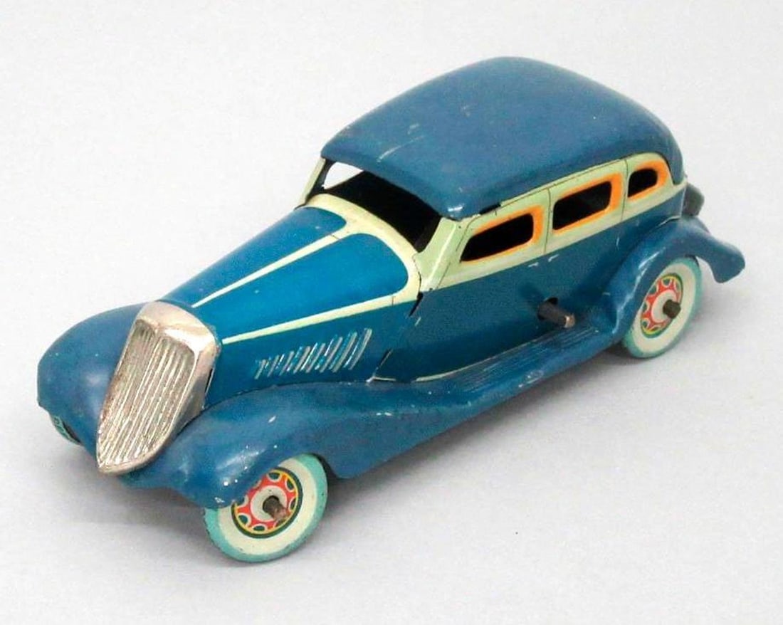 Kosuge, Graham Paige "No. 3" car: Circa 1933, a lithographed tinplate clockwork blue car with pale green trim; orange window frames; black spare wheel cover and chromed radiator grille. Dimensions: 2.25" x 6.25" x 2" (5.7 x 15.9 x 5.1