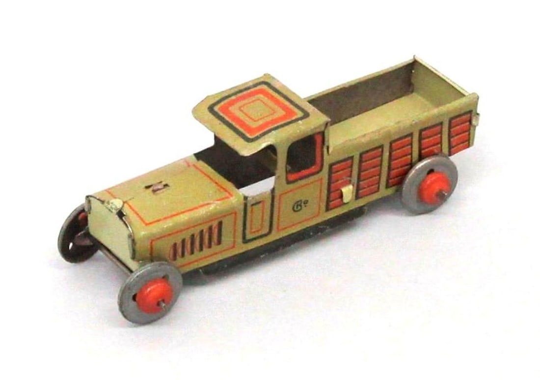 Kellerman Toy Manufacturer Penny Truck: Tinplate toy penny truck by Kellerman having a green exterior with black and red trim. Dimensions: 1.25" x 1" x 3.5"" (3.2 x 2.5 x 8.9 cm). Condition: Top of cab is bent inwards. Scratches scattered t