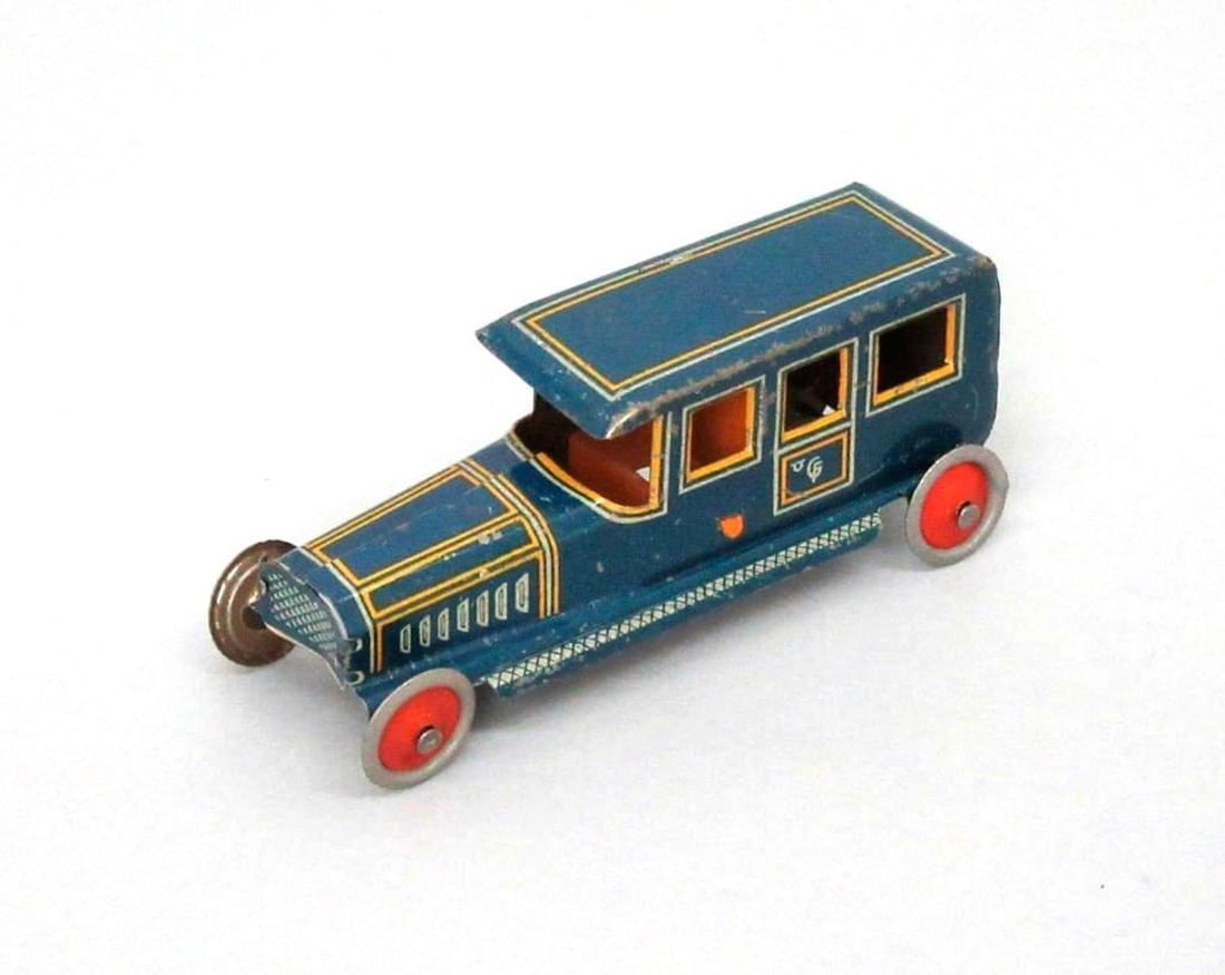 Fischer Penny Limousine Car: Small tinplate toy limousine car; blue exterior with orange interior; red hubcaps painted on wheels; Fischer manufacturer's logo on both doors. Medium: metal, paint. Dimensions: 1" x 1" x 3.5" (2.5 x