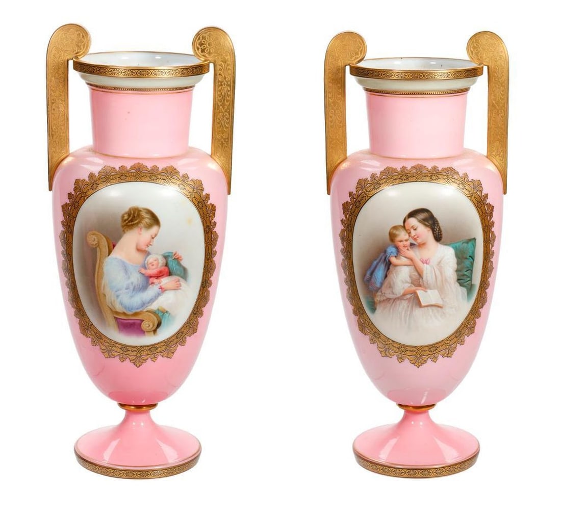 Pair Bohemian Portrait Glass Vases: Each pink opaline glass footed urn centering a hand painted portrait medallion of a mother and a child, each with applied gilt handles, each 17"h [Overall good condition]