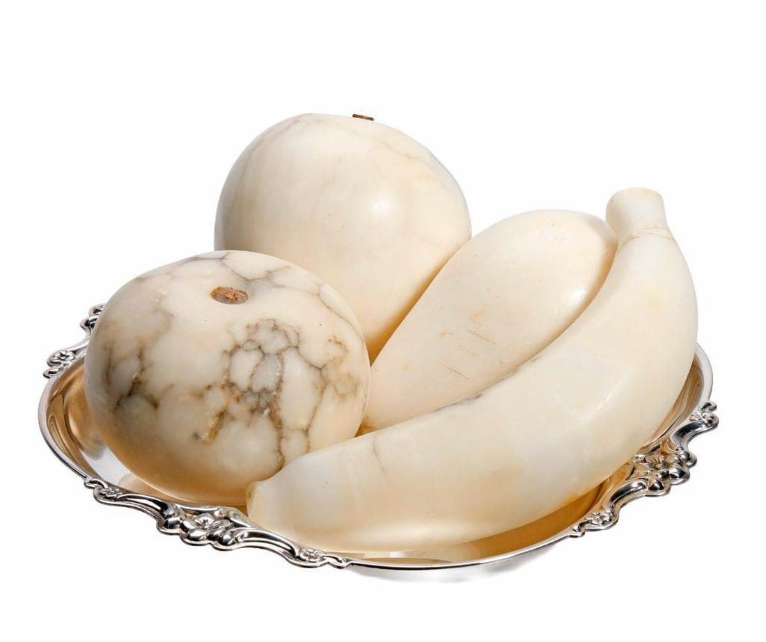 Lot of Italian Marble Specimen Pieces of Fruit: Comprising a white marble veined carved apple, a peach, a pear and a banana, the largest 5.5"l {repaired stem}; en suite with an International plated quadrilobe dish 7.25"d