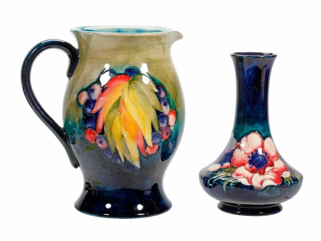 Two Moorcroft Tubeline Vessels: Comprising a "Leaf & Berry" pattern pitcher shading from green to cobalt blue 7"h; and an "Anemone" vase 6.25". [Provenance: Estate of Joan A. Nitis, San Francisco.]
