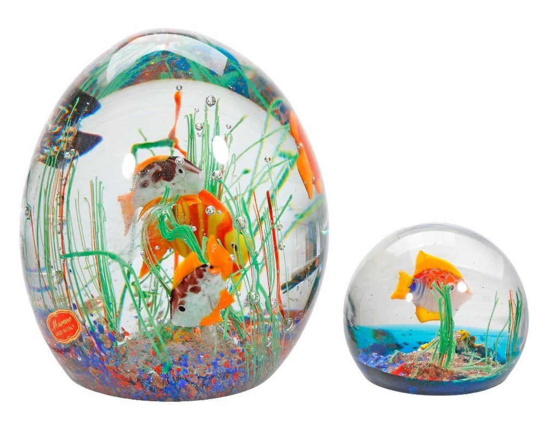 Two Murano Aquarium Paperweights: The larger weight encasing five swimming fish, with a Murano Italy paper label 5.75" x 5"; the smaller one with single fish 2.5" x 2.5" [Overall good condition] 