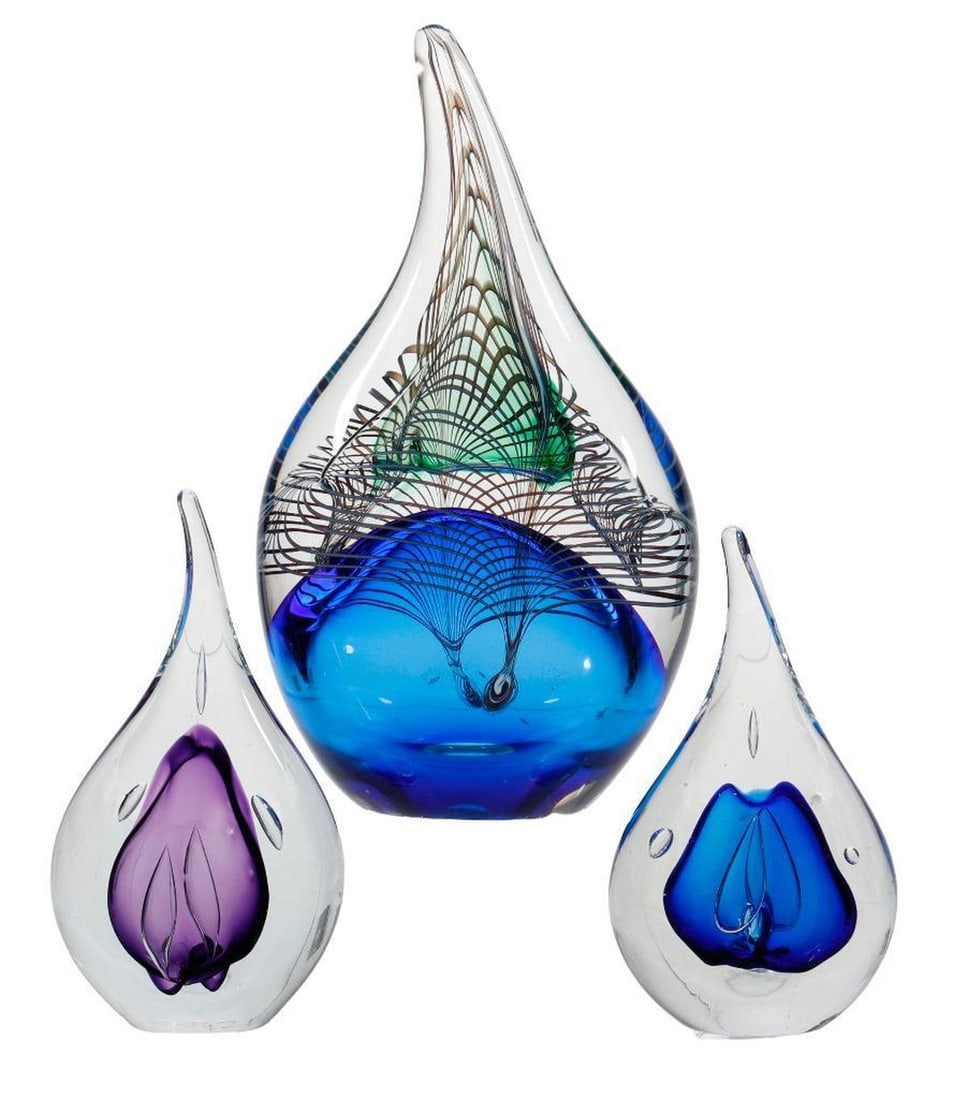 Three Polish Adam Jablonski Paperweights: Each of tear drop form, the largest, a Nexus weight with a peacock feather design and a blue interior core, signed, 9.25"h and a smaller pair encasing a blue or a purple core, both with paper labels, 