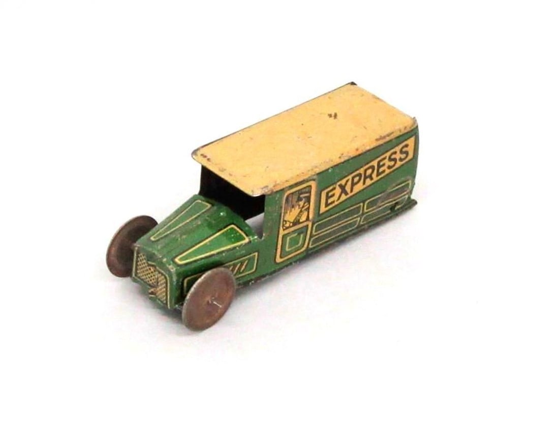 Einfalt Toy Manufacturer Express Delivery Van: The green toy delivery van with yellow roof; "Express" and image of driver painted on sides; "G.E. 183" painted on bumper. Dimensions: 1" x 1.25" x 3" (2.5 x 3.2 x 7.6 cm). Condition: Missing rear whe