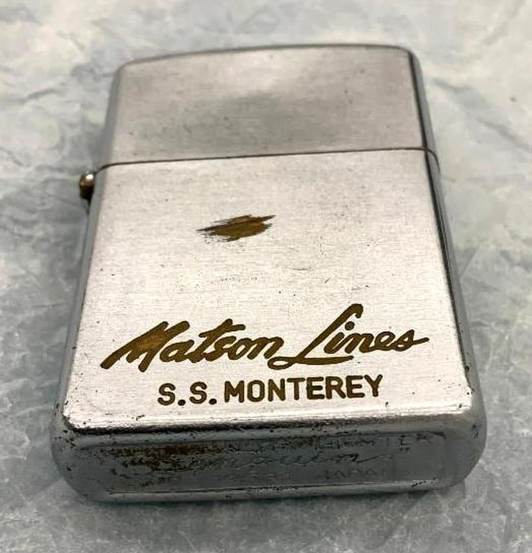 Matson Lines Penquin Lighter: The silvered metal case with a flip top, enameled "Matson Lines, S.S. Monterey". Dimensions: 2.25" x 1.5" x .25" (5.7 x 3.8 x .6 cm)