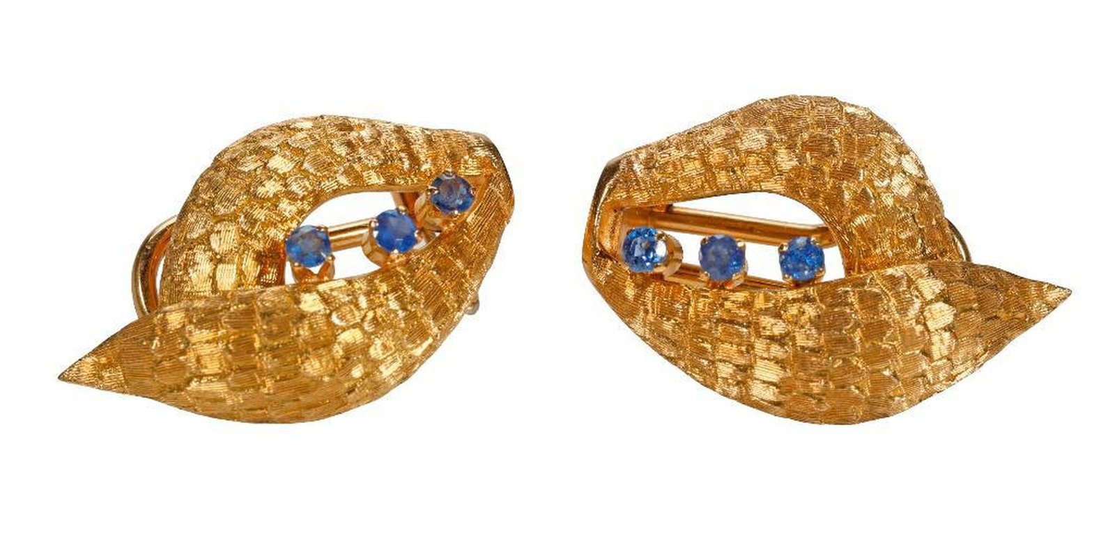 A pair of sapphire and 18k gold clip-earrings, Italy: mid-century, the textured gold stylized leaf motif earrings set with six round sapphires; weighing approximately 9.8 grams; length: 1 in.