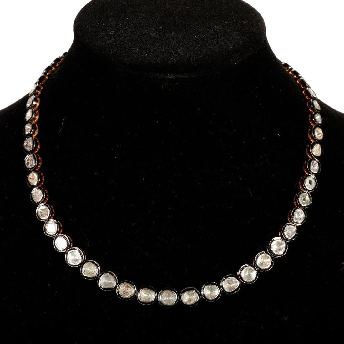 A diamond, silver and gold riviere necklace: the riviere design set with 56 graduating polki diamonds; weighing approximately 59.6 grams; length: 19 1/2 in.