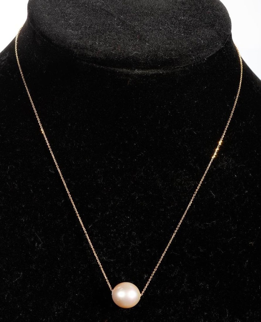 A South Sea cultured pearl and 14k gold necklace: featuring a South Sea cultured pearl measuring approximately 13.0 x 11.5mm, one a fine link chain; weighing approximately 3.8 grams; length: 16 in.