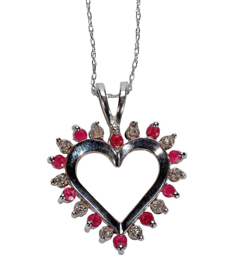 A gem-set and 10k white gold reversible pendant-necklace: the heart-shaped pendant with 20 single-cut diamonds, and ten round rubies to one side, and ten sapphires on reverse; weighing approximately 4.2 grams; pendant length: 1 in; chain; 18 in.