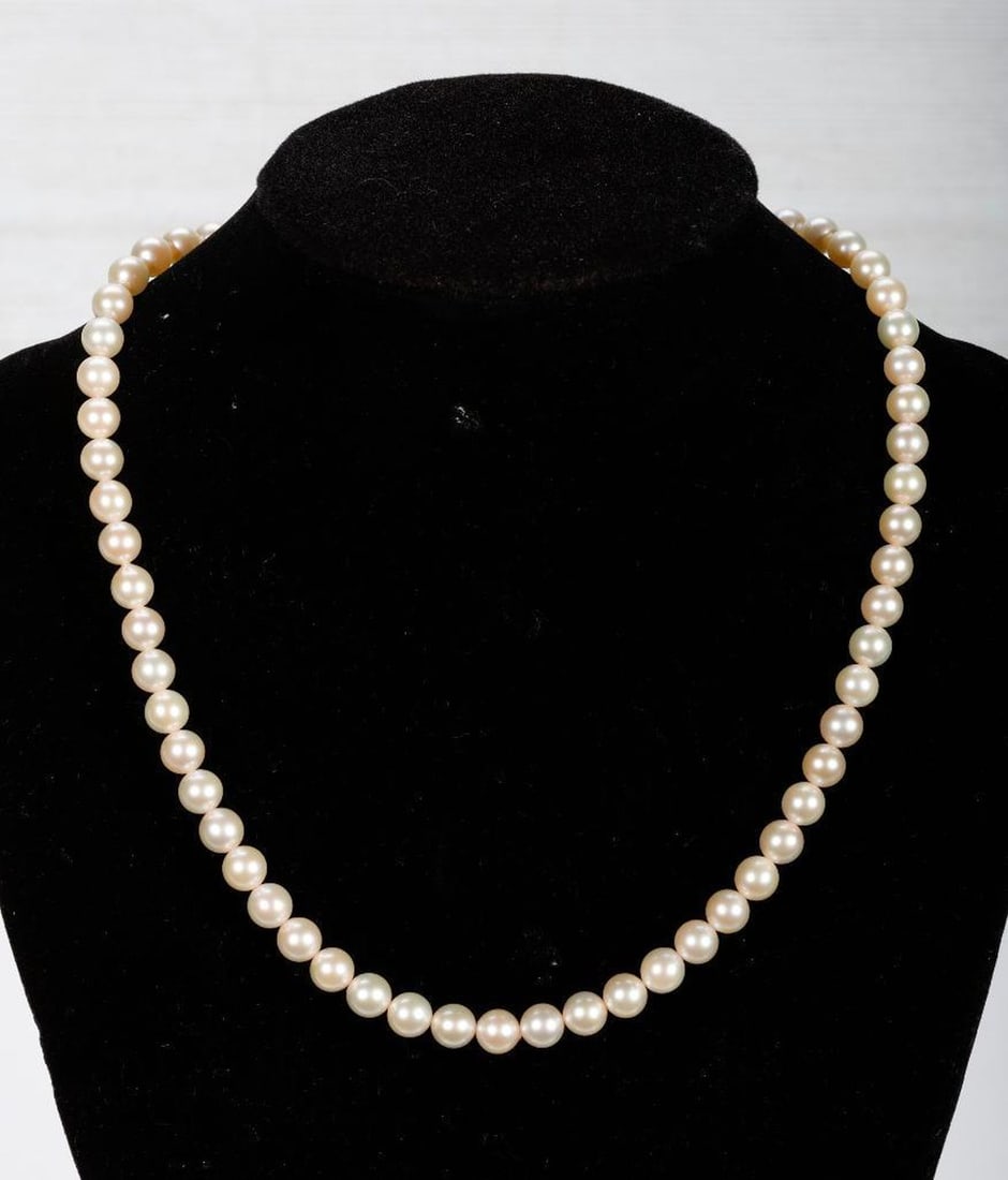 Cultured pearl necklace: composed of 63 cultured pearl beads, measuring approximately 6.0 - 6.50mm, completed by a silver and 14k white gold clasp; length: 16 in.
