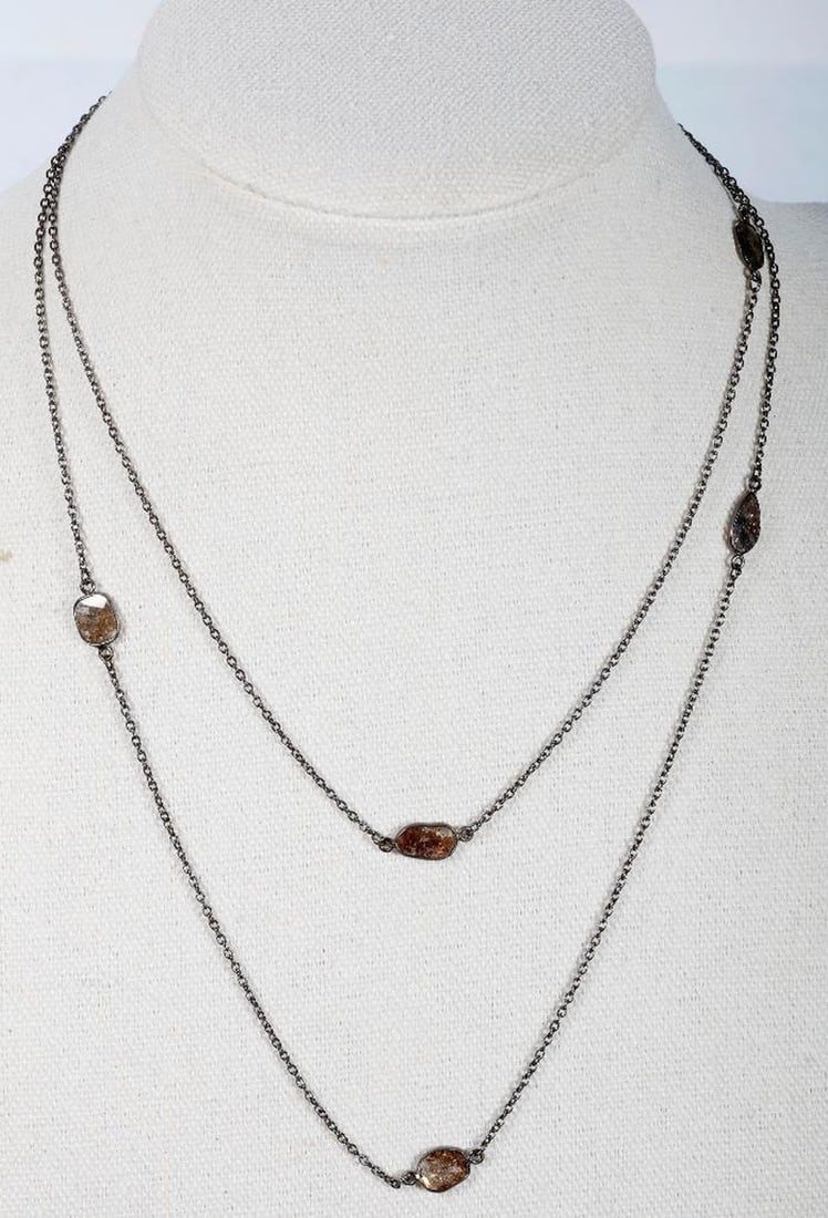 A diamond and blackened silver longchain: designed with bezel-set diamond slices weighing in total 5.50 carats; length: 36 in. 