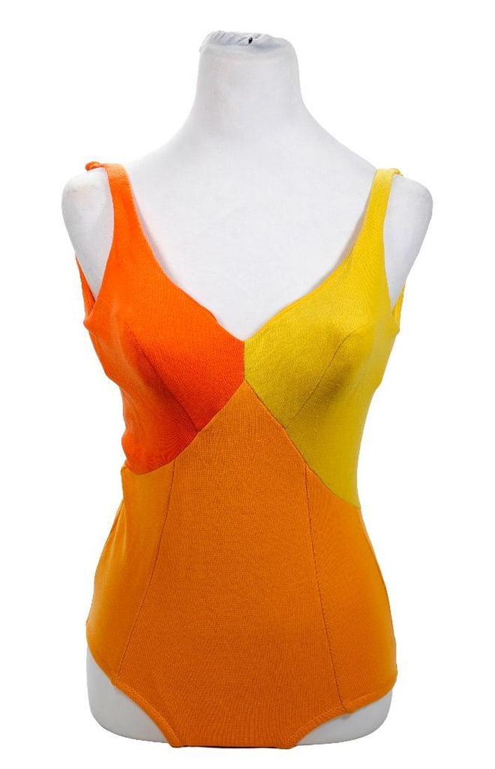 Vintage Oleg Cassini Peter Pan Swimsuit, 1960s: An original 1960s nylon one-piece swimsuit labeled Peter Pan, Oleg Cassini Collection; in bright yellow, peach, and orange color blocks; with button straps and bra cup liners on elastic tethers. Appro