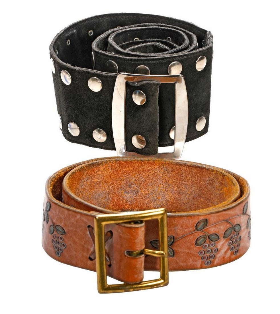 Two Vintage Leather Belts, 1970s: A black suede wide belt with silver-toned metal studs and buckle, 3" W x 43" L; and a brown leather belt with hand-tooled grape vine decoration, gold-toned buckle, the inside hand inscribed "For I. Ma