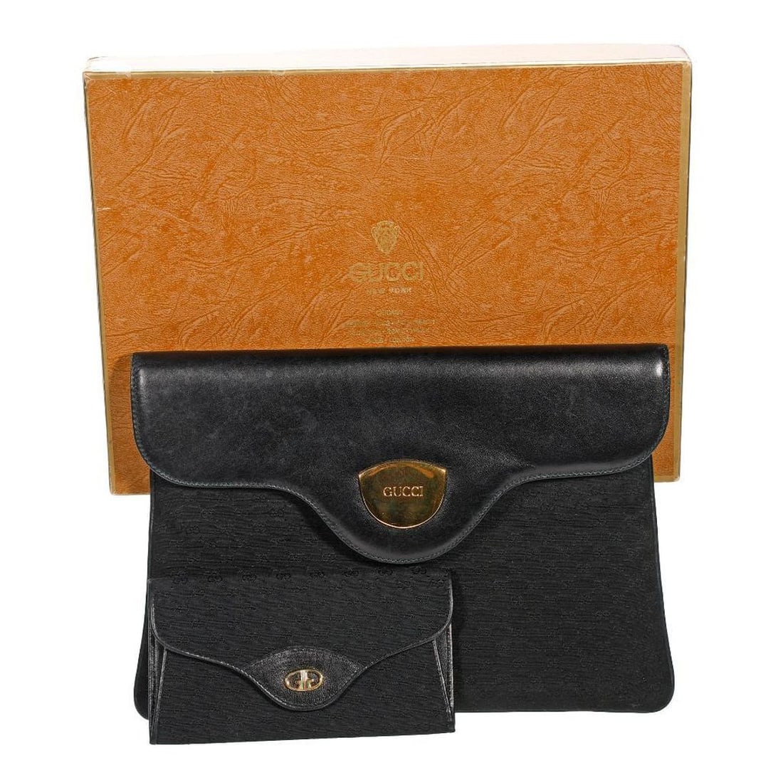Vintage Gucci Clutch Purse and Wallet: The Gucci clutch purse with black micro GG monogram fabric body and black leather tab-shaped flap with Gucci embossed gold-toned medallion, snap closure, the leather interior gilt-stamped "Made in Ita