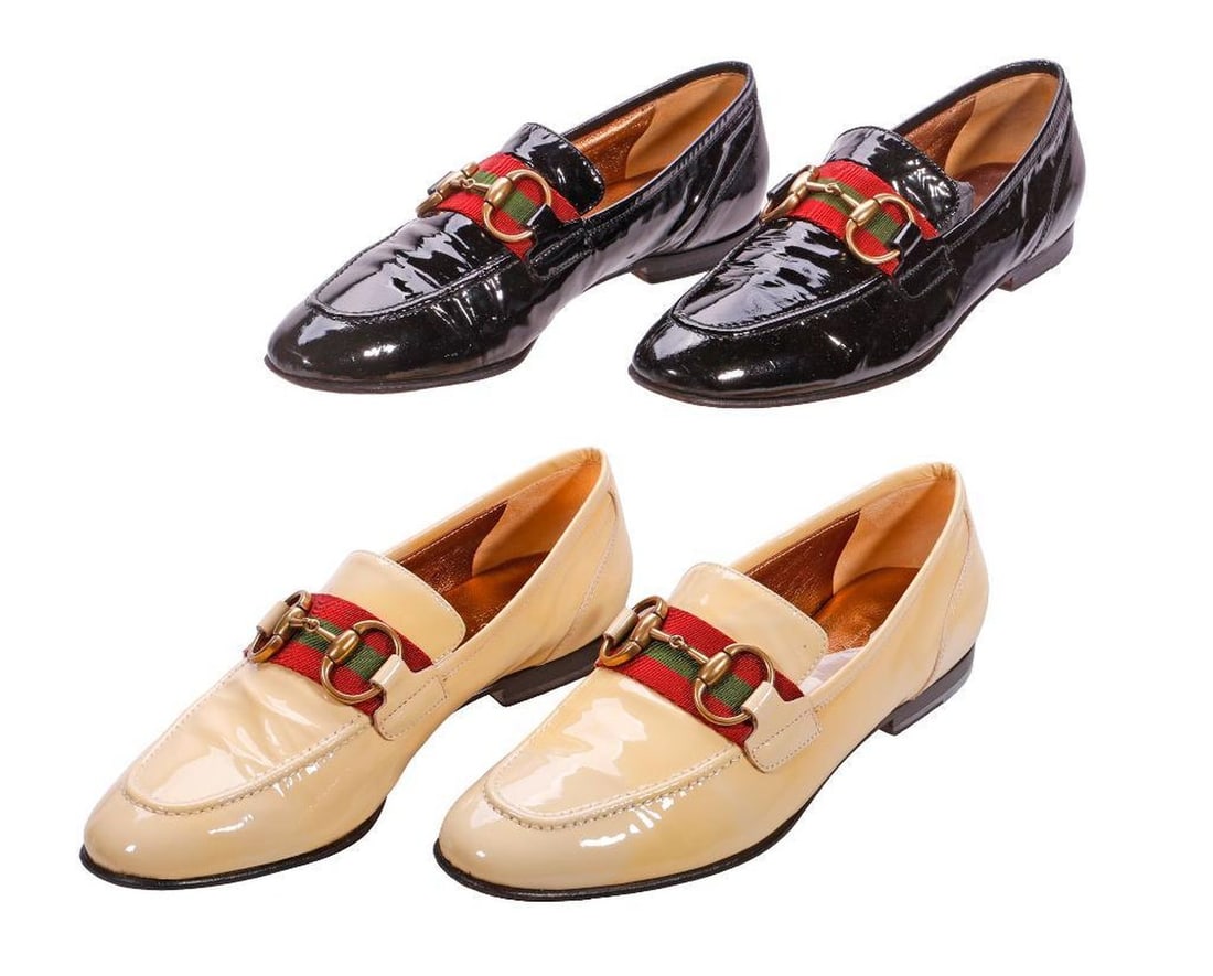 Two Pairs Vintage Gucci Patent Leather Loafers (Sz 7B): Two pairs of women's Gucci Made in Italy patent leather loafers, one black, one cream, both with gold-toned metal and ribbon embellishments. Overall good vintage condition with moderate wear; the