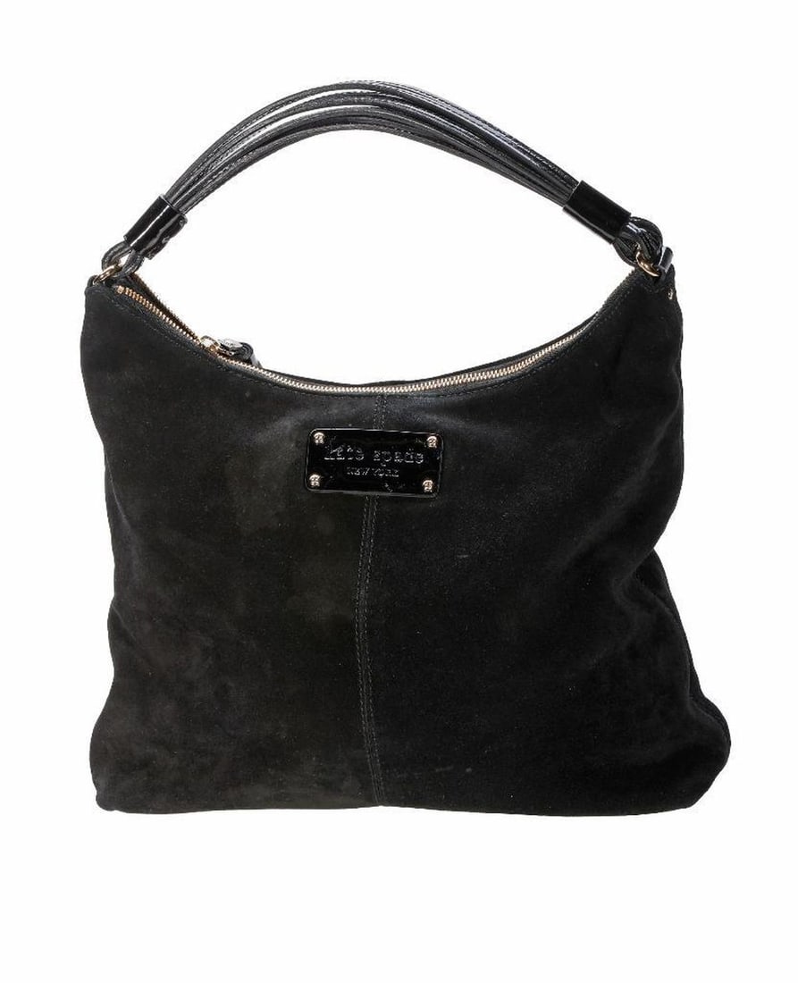 Vintage Kate Spade Black Suede Handbag: The Kate Spade, New York labeled black suede bag with handle of patent leather cord, the interior lined in polka dot fabric. 11" x 14 1/2" x 3." Overall good vintage condition, but for several light s
