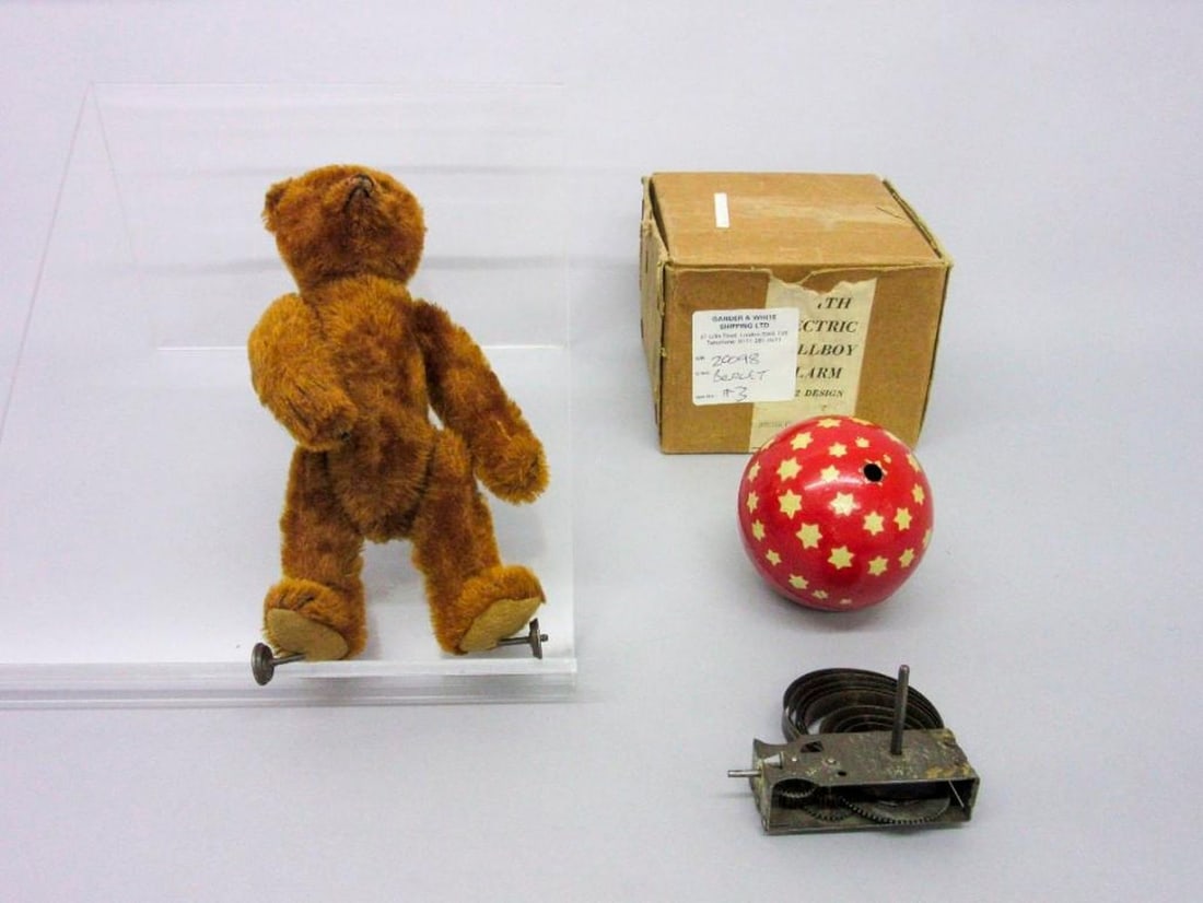 Bing Werke Teddy Bear: Circa 1914. Bing cinnamon plush teddy bear with button under left arm, stitched snout, black button eyes and swivel jointed body with excelsior filling, metal disc wheels to feet, the right paw