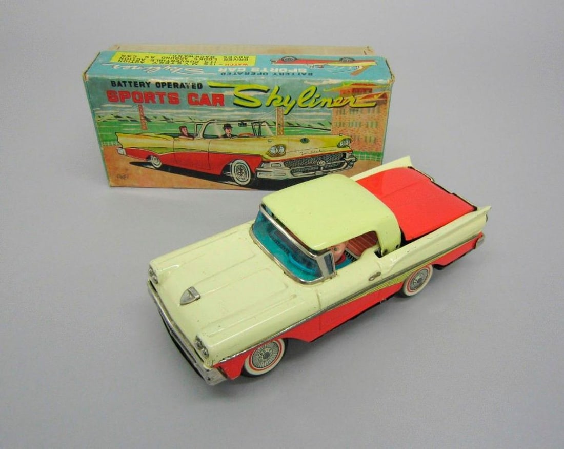 Japanese Kosuge Ford Skyliner car: Toy Ford Skyliner car with retractable hood; driver; battery-powered, "Made in Japan"stamped on bottom. .02: Original cardboard box with lid; color illustration of Ford Skyliner on lid; maker Kosuge