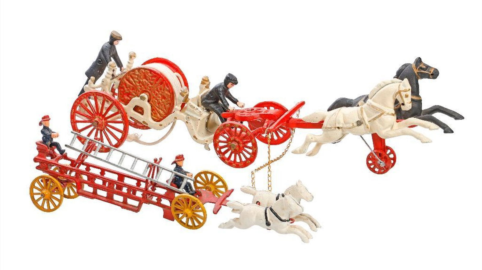 Two Cast Iron Fire Carriages: The largest with a pair of horses (white and black) suspended on wheels pulling an ivory and red painted cart being "driven" by a seated man and a rear figure tending the rolled up white rope