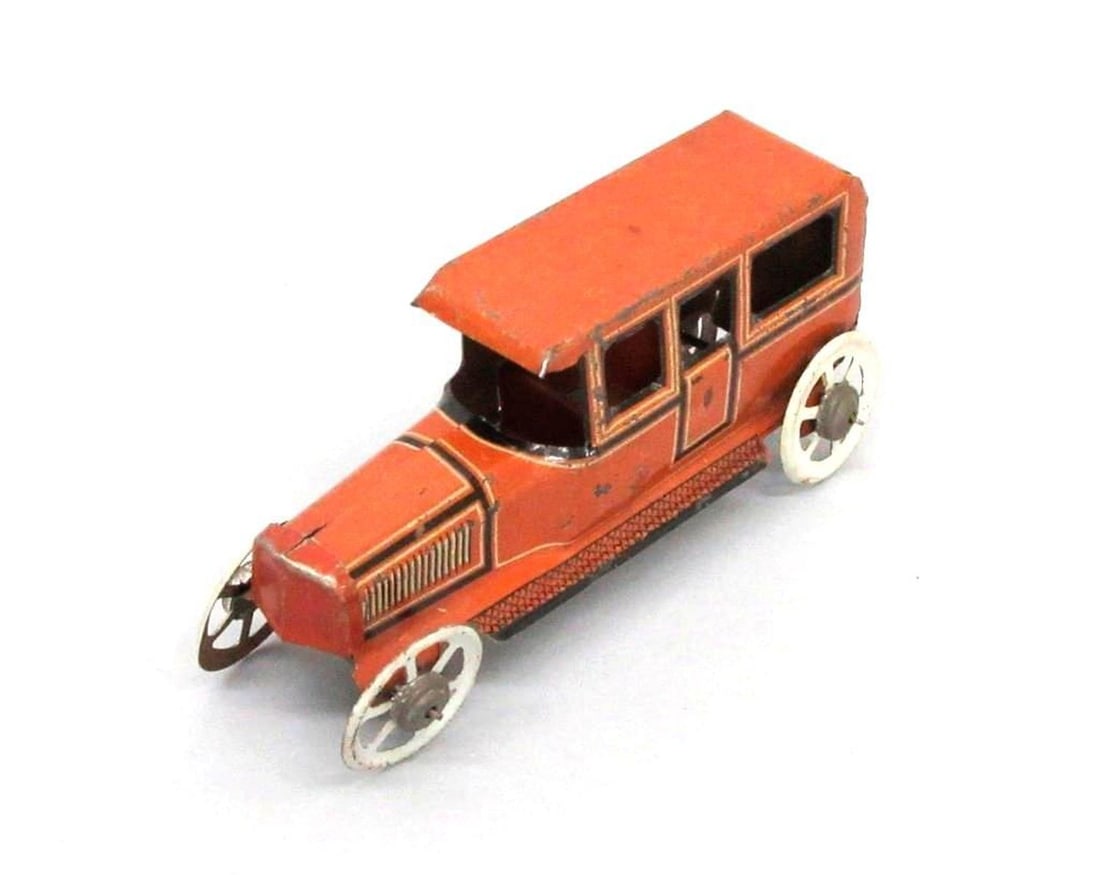 Fischer Penny Limousine Car: A small tinplate toy limousine car; brown exterior with white wheels; Fischer manufacturer's logo on both doors. Dimensions: 1.75" x 1.5" x 4" (4.4 x 3.8 x 10.2 cm). Condition: Scattered small