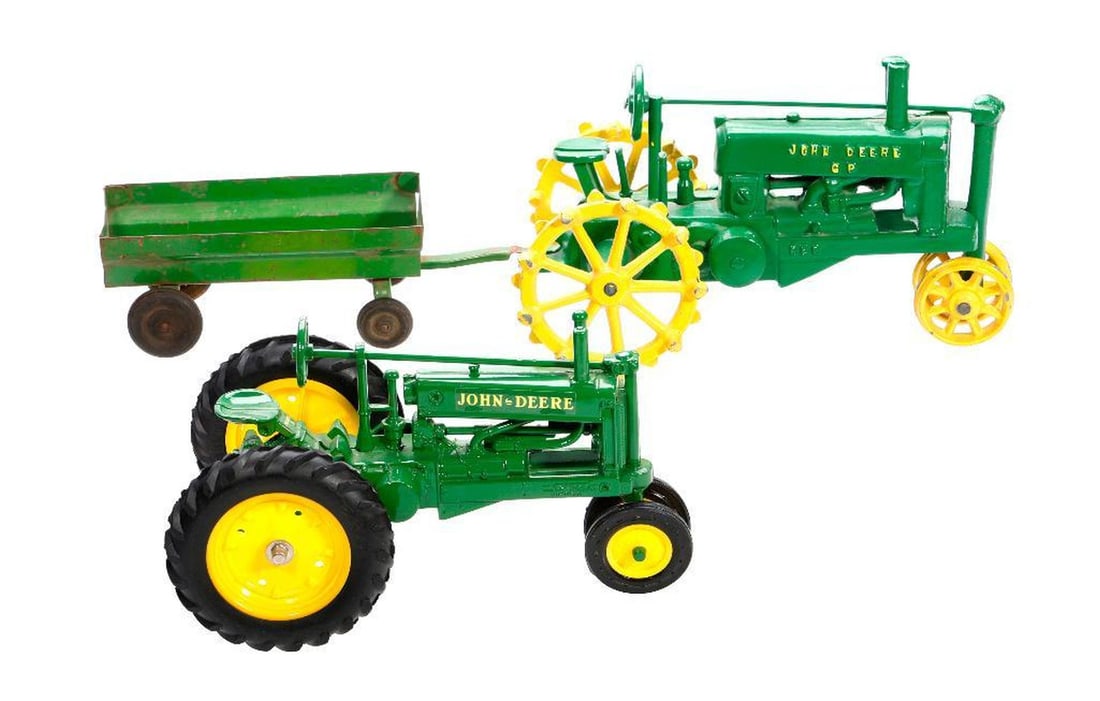 Collection of John Deere Tractors and Historical Replicas: Made by Ertl, comprising two 1/16 scale tractors including a cast iron train 5.25"h x 8.5"w x 5"d {some paint loss} and a John Deere 1934 Model "A" die cast metal tractor with rubber tires, 5"h x