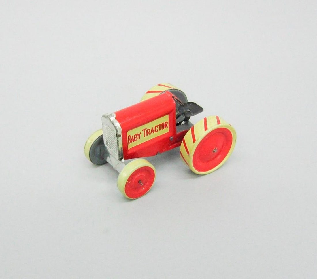 Animate Toy Baby Tractor: Yellow body with white wheels. .02: original card stock box; "Baby Tractor" printed on top of lid; color illustration of tractor, boys, and animals on top and sides; instructions on bottom. Dimensions
