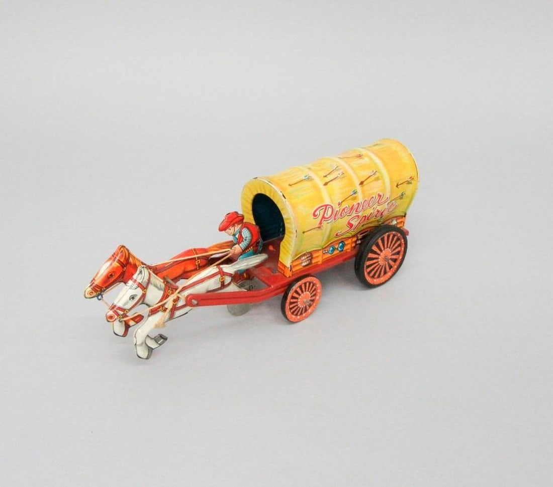 Japanese Alps Shoji Pioneer Spirit Wagon with Horses and Driver: Toy wagon with two horses and driver; "Pioneer Spirit" printed on wagon; Alps Shoji manufacturer's mark. Dimensions: 3.5" x 3" x 9.5" (8.9 x 7.6 x 24.1 cm). Condition: Abrasions on sides of horses.