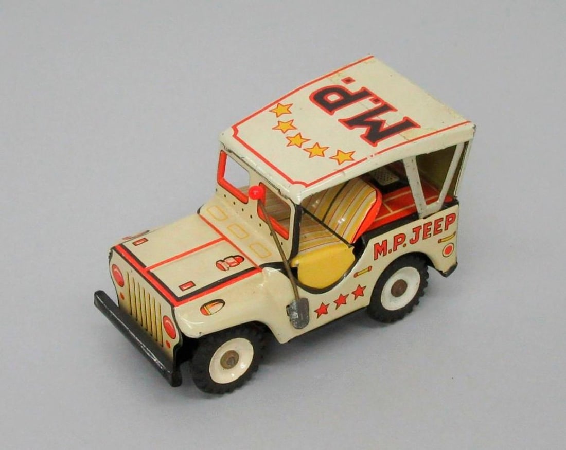 Sanesu M.P. Jeep: A tan/light yellow colored jeep with red lines and stars; illustration of red eagle on the back and red and yellow oil tank; five yellow stars with red border and "M.P." on the roof; Sanesu