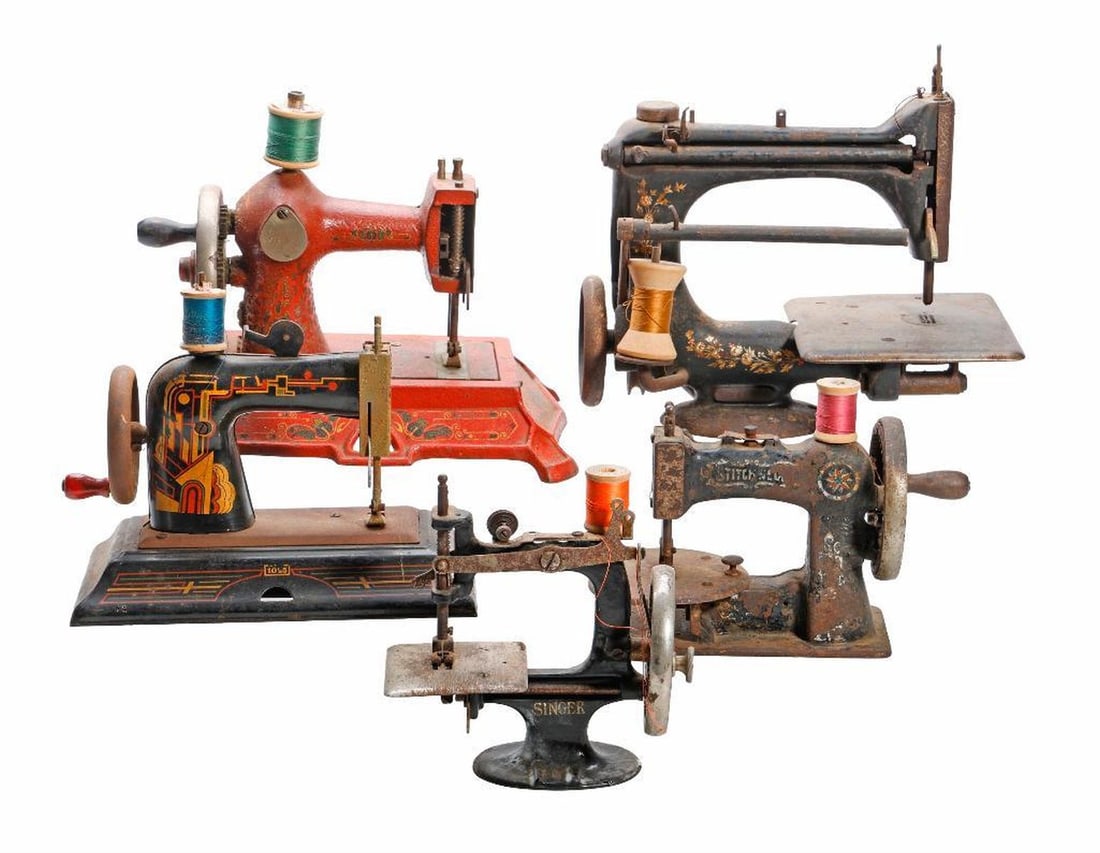 Six Art Nouveau Miniature Sewing Machines: Four with cast iron bodies and two with litho tin bodies, Including Stichwear; a Midget; a Singer; and a Casige Model #1025