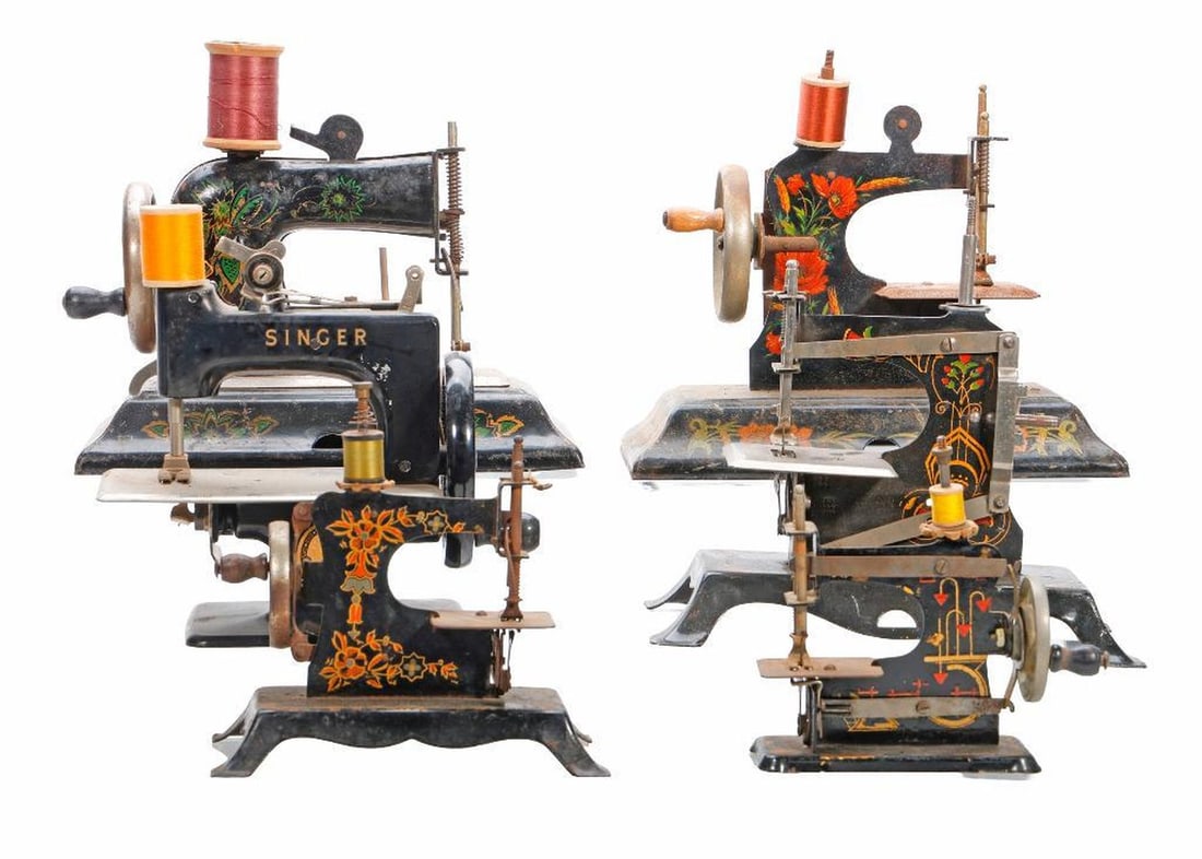 Nine Art Nouveau Miniature Sewing Machines: Including (2) Singer; the Smith & Egge Mfg. Co. "The :ittle Comfort"; (2) German stencil decorated tin miniatures; the largest 7"h x 8.5"w x 5"d