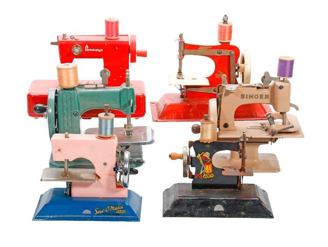 Four Mid Century Miniature Sewing Machines: Including a Deco green Betsy Ross miniature: (2) Sew-O-Matic Juniors; a tan SInger and a red Penney models; the largest 7"h x 8.25"w x 4.5"w