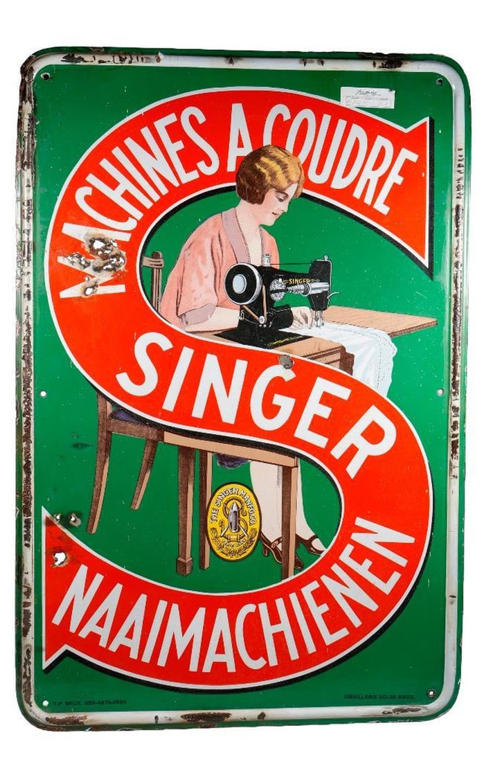 German Singer Sewing Machine Enameled Sign: The single sided and rolled edged rectangular sign centering a seated figure of a lady in a pink dress using a sewing machine, superimposed with a giant letter "S" reading "MACHINES