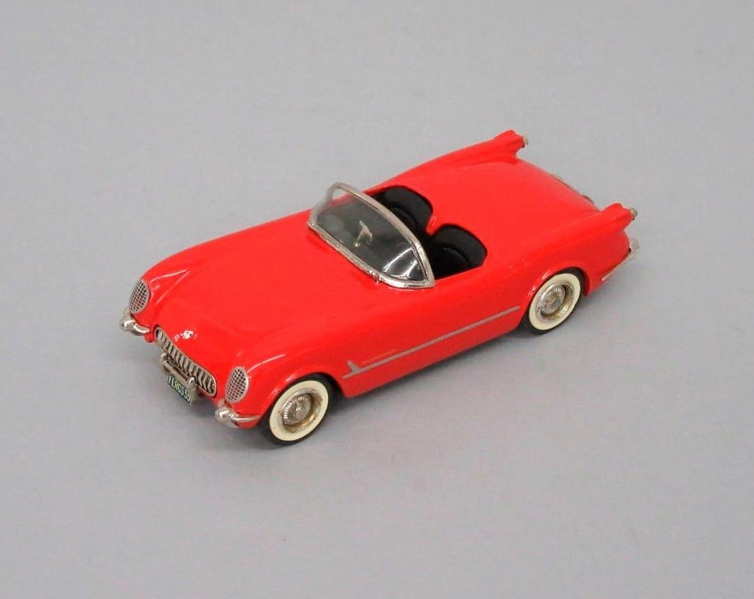 Western Models Chevrolet Corvette Car: Bright red Chevrolet Corvette toy car; black interior; plastic windshield; white tires; "WM / Corvette 1953-5 / Small Wheels" stamped on underside. Dimensions: 1 x 1 1/2 x 3 3/4 inches (2.5 x 3.8 x 9.