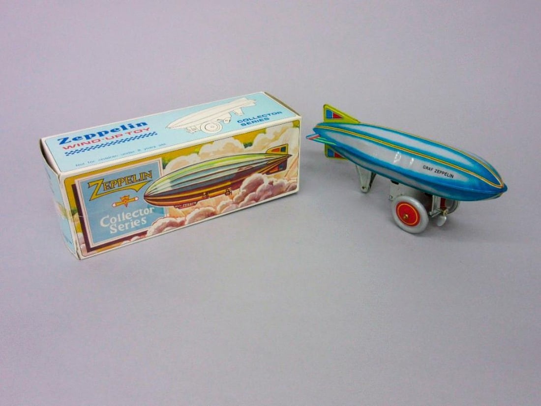 Wind-up Zeppelin: In original box, with key. Dimensions: 9 1/2 x 3 3/4 x 3 1/2 inches (24.1 x 9.5 x 8.9 cm) SFO Museum Deaccessioning Project SFO Museum is conducting a review and downsizing of our holdings that fall