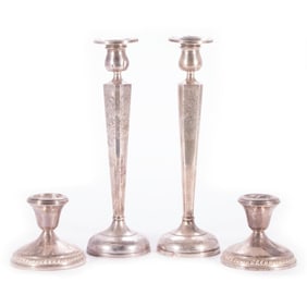 Four Sterling Weighted Candlesticks.