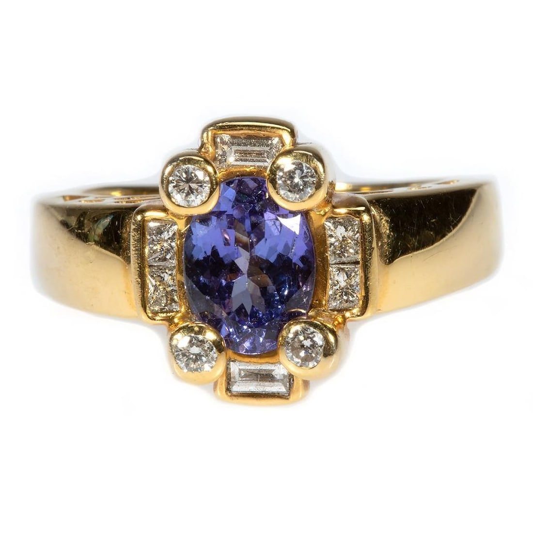 Tanzanite, diamond and 14k gold ring: set with an oval tanzanite weighing an estimated 1.00ct., with 9 round brilliant, princess and baguette-cut diamonds weighing in total an estimated 0.35ct,. H-I/VS; weighing approximately 6.8 grams;