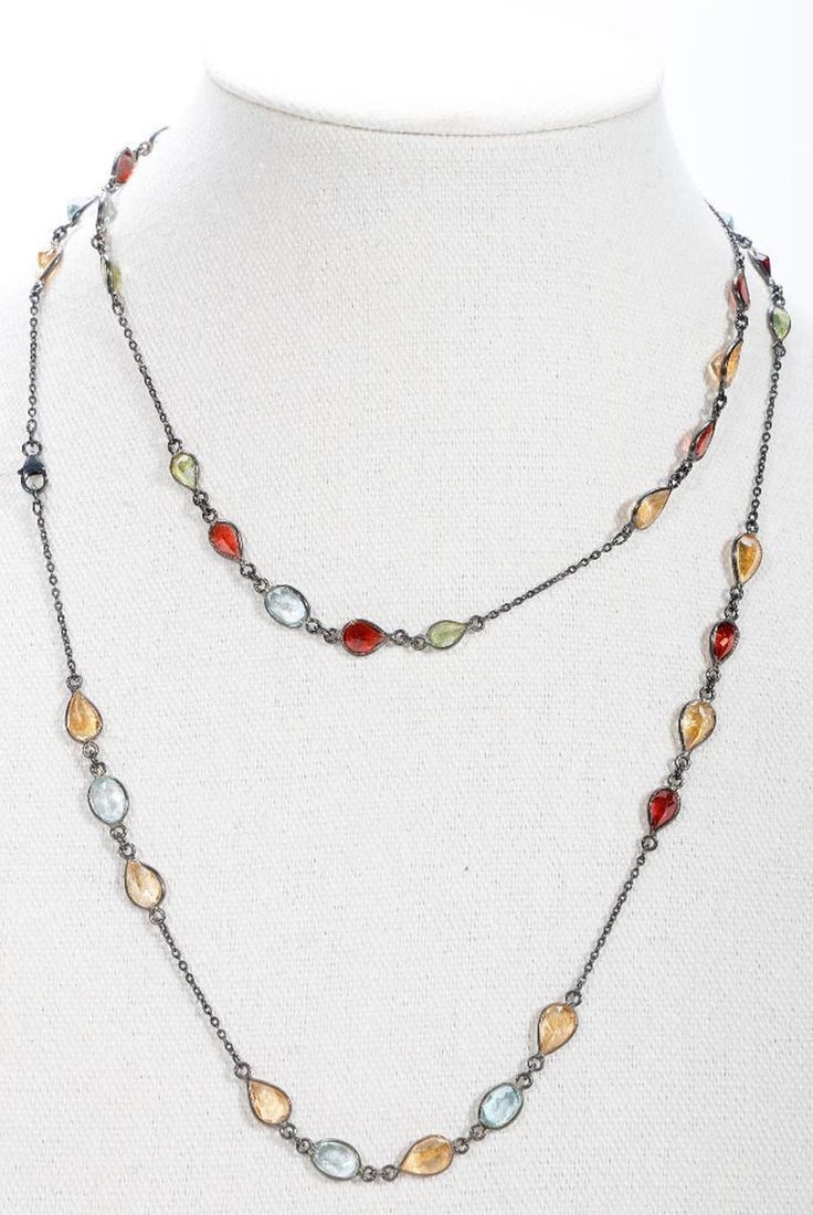 A semi-precious and blackened silver necklace: bezel-set with pear-shaped semi-precious stones including peridot, garnet, topaz and quartz; estimated total gem weight: 89 carats; weighing approximately 17.74 grams; length; 36 in.
