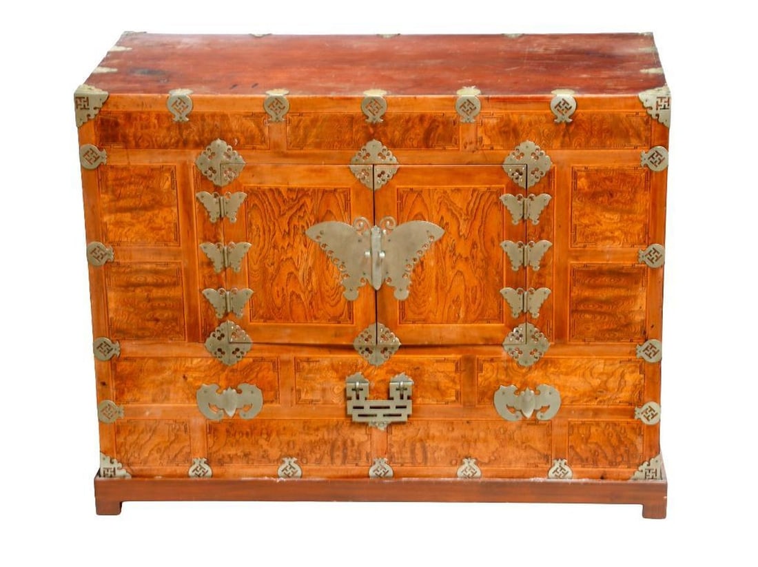 Pair Korean Butterfly Chests: Each chest having twin doors centering with a large butterfly estucheon plate opening to reveal a cupboard, the facade with with smaller butterfly, bat and fruit form mounts. Each with 